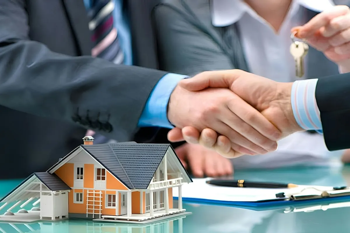 Agent handing house keys to a buyer