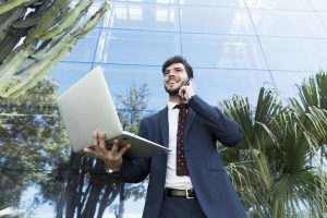 low-angle-lawyer-holding-his-laptop